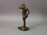 bronze statue of a boy on a pedestal with his hand on his hip