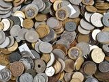 a pile of coins sitting on top of a white table
