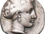 a silver coin with a woman ' s face on it