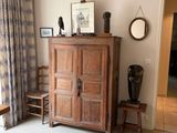 a wooden cabinet in the corner of a room