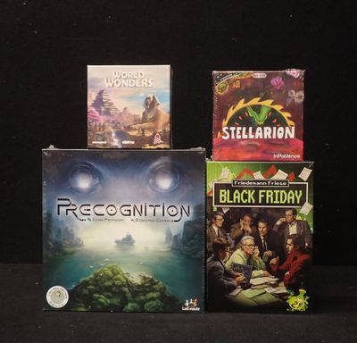 three video games sitting on top of each other on a table