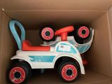 a toy car in a cardboard box with wheels on it