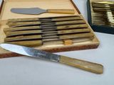 a box of knives and a knife sharper on a table