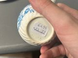 a person holding a cup with a sticker on it
