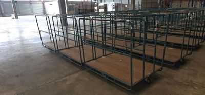 many carts that are lined up in a warehouse