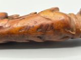 a statue of a man laying down on a white surface