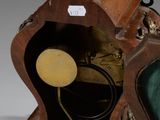 a wooden clock that is sitting on a table