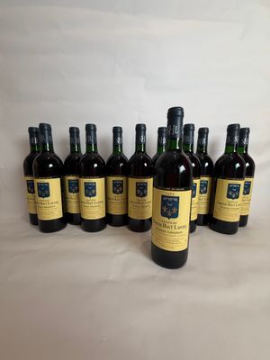 six bottles of wine are lined up on a white surface