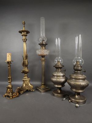 four different types of candles and a candle holder on a table