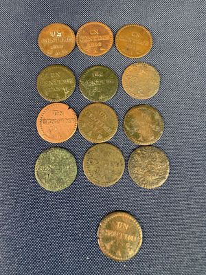 a bunch of coins sitting on top of a blue cloth