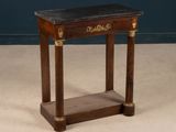 a small wooden table with a marble top on it