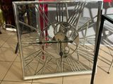 a red table with a mirror and a bike wheel on it