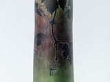 a green vase with a picture of a bird on it