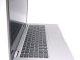 a silver laptop with a black keyboard on a white surface