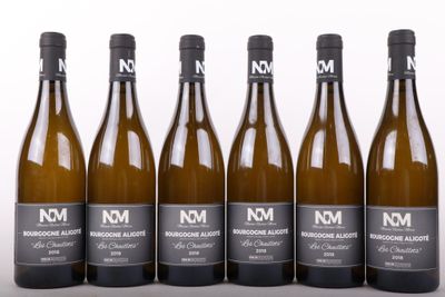 six bottles of wine are lined up in a row on a table