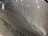 a close up of a car ' s door handle with a sticker on it