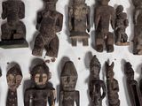 a lot of wooden figurines that are on the wall