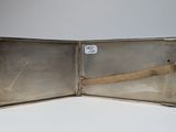 a silver case with a handle and a strap