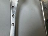 two spoons that are sitting on a table