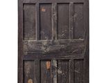 an old wooden door with a wooden handle on it