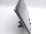 a tablet computer sitting on a stand on a white surface