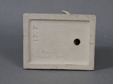 a small white box with a hole in it