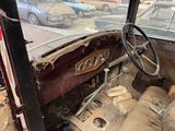 an old car that is sitting in the dirt