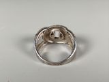 a close up of a silver ring on a white surface