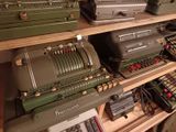 many old typewriters sitting on a shelf in a room