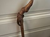 a wooden stick that has a bird on top of it