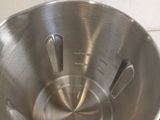 a large metal bowl on the stove with a measuring scale