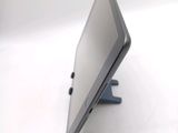 a laptop computer sitting on a stand on a white surface