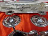a silver tray with silver spoons and spoons on it