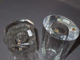 two clear glass vases sitting on a table