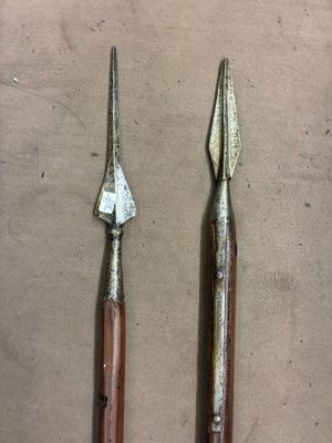 two old tools are sitting on a table next to each other