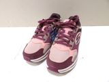 purple and pink new balance shoes on a white surface