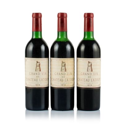 three bottles of red wine sitting next to each other on a white surface