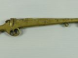 a picture of a brass gun with a tag on it