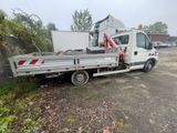 a white truck with a crane on the back of it