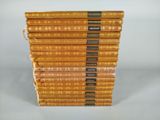 several books stacked on top of each other on a white surface
