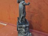 a statue of a woman standing on top of a clock