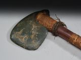 an old axe with a wooden handle on a white surface