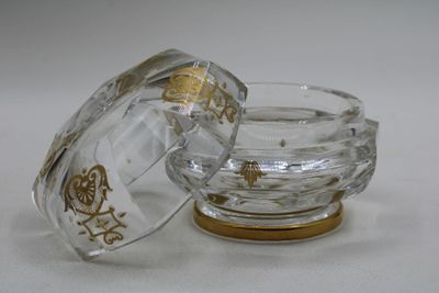 a small glass bowl with a lid on a white surface