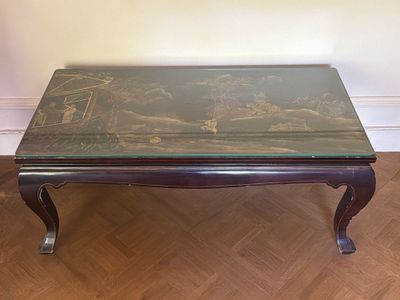 a coffee table with a glass top on a wooden floor