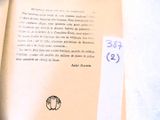 a close up of an open book with a sticker on it