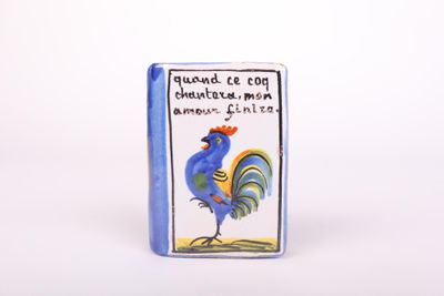 a close up of a blue book with a rooster on it