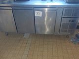 a stainless steel counter with two pots on top of it