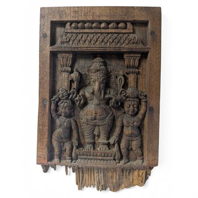 an image of a wooden wall hanging with a statue of a man and a woman