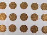 a group of gold coins sitting on top of a white surface