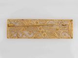an image of a gold broochle with intricate designs